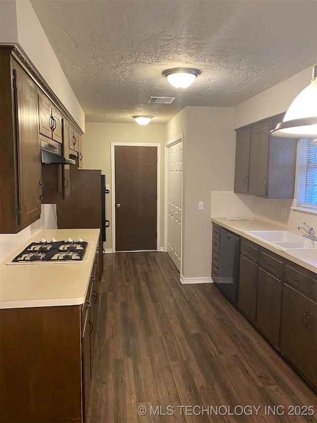 kitchen with dishwasher, dark brown cabinets, sink, and white gas cooktop