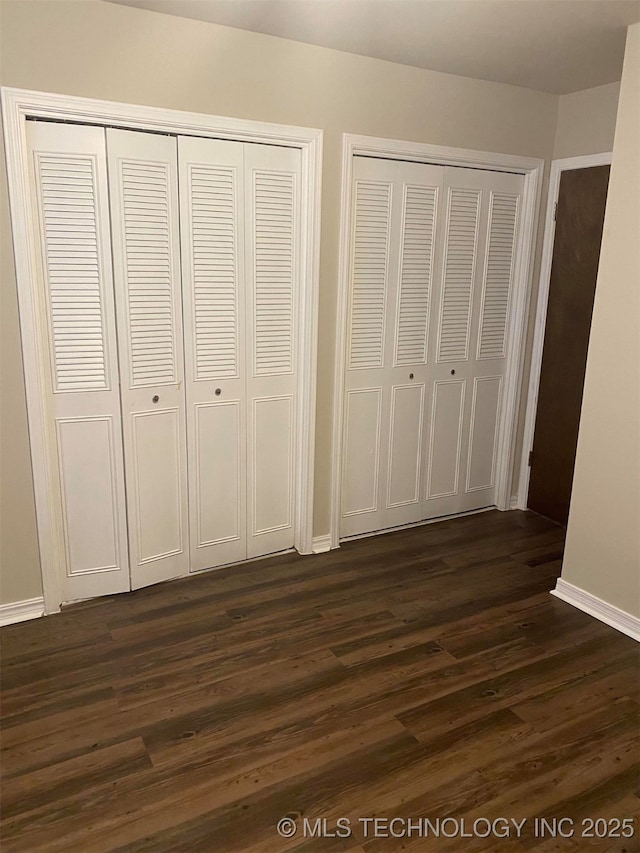 unfurnished bedroom with dark hardwood / wood-style floors