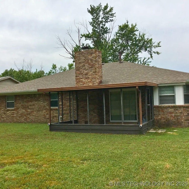 rear view of house with a yard