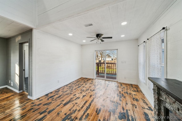 unfurnished living room featuring ceiling fan, a fireplace, and hardwood / wood-style flooring