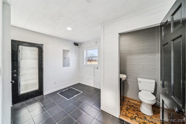 bathroom featuring toilet and electric panel