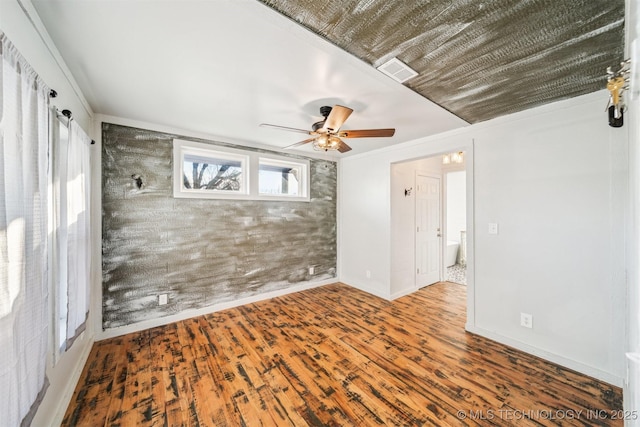 spare room featuring hardwood / wood-style floors, ceiling fan, and ornamental molding