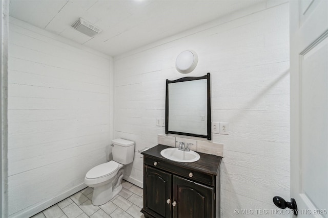 bathroom with tile patterned flooring, vanity, and toilet