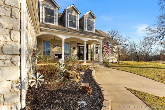 cape cod-style house with a porch and a front yard