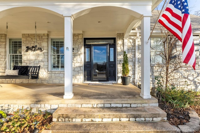 property entrance with covered porch