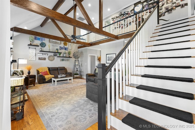 interior space with beamed ceiling, light hardwood / wood-style floors, high vaulted ceiling, and ceiling fan