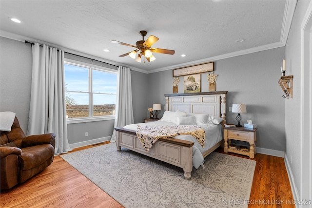 bedroom with ceiling fan, crown molding, a textured ceiling, and light wood-type flooring