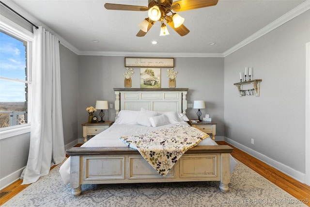 bedroom featuring ceiling fan, crown molding, and light wood-type flooring