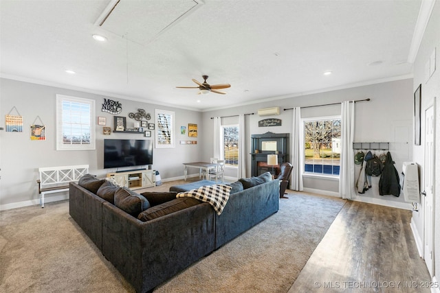 living room with ceiling fan, an AC wall unit, ornamental molding, and light hardwood / wood-style flooring