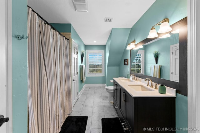 bathroom with tile patterned flooring, vanity, and toilet