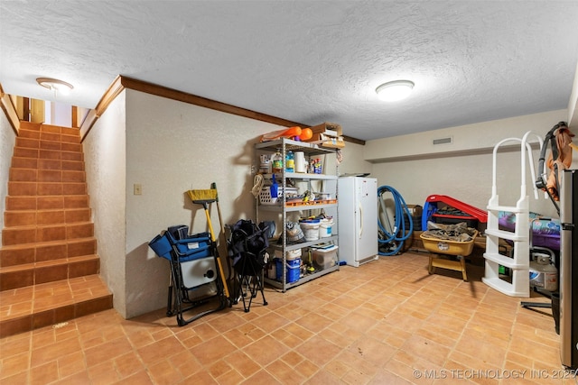 interior space with a textured ceiling and ornamental molding