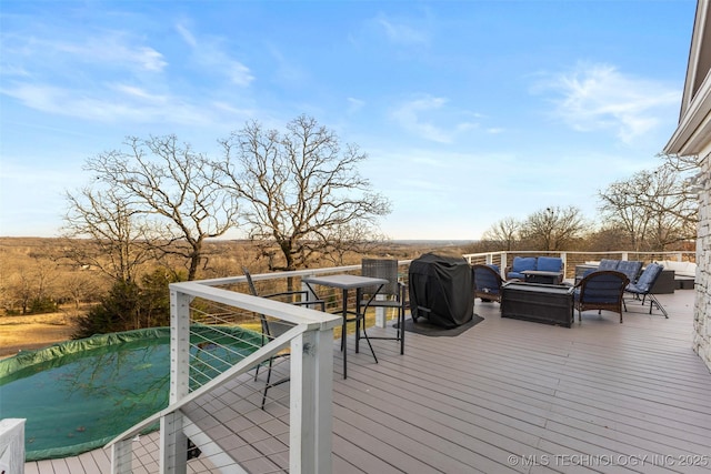 wooden terrace with outdoor lounge area and area for grilling