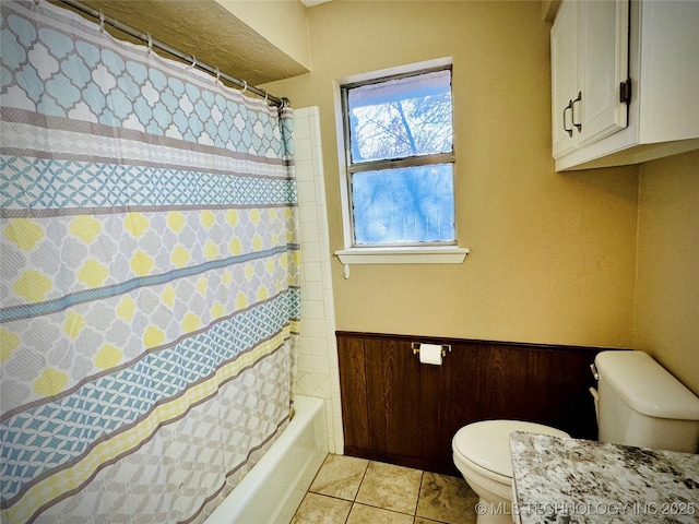 bathroom featuring tile patterned floors, toilet, wood walls, and shower / bathtub combination with curtain