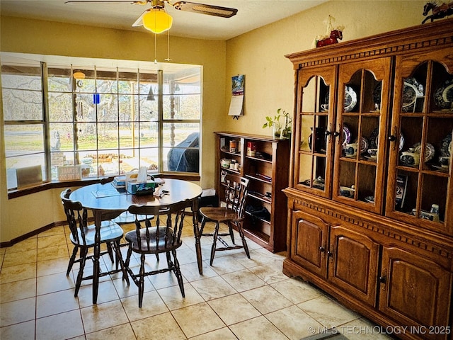 dining space with ceiling fan and light tile patterned floors