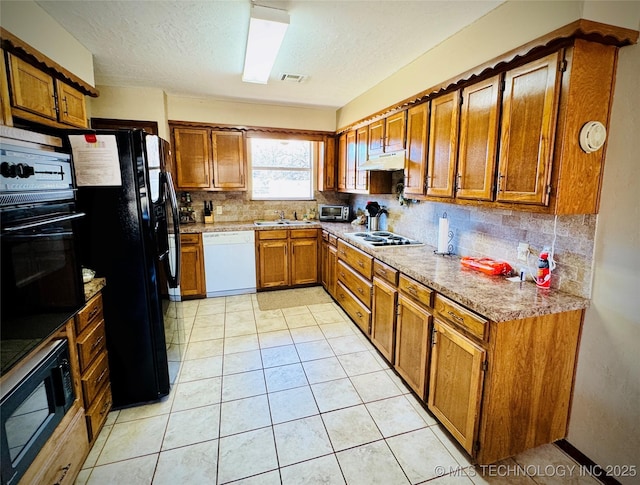 kitchen with light tile patterned flooring, sink, tasteful backsplash, and black appliances