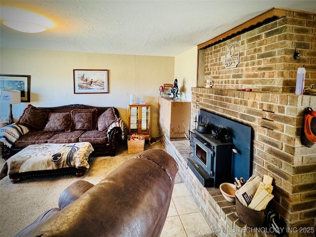 living room with a textured ceiling, light tile patterned floors, and a wood stove