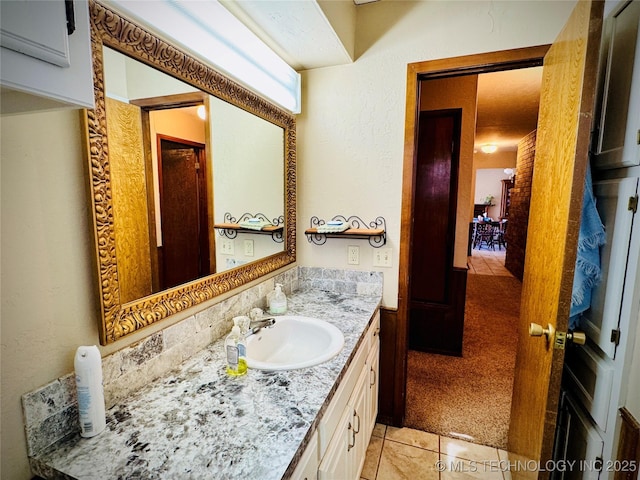 bathroom featuring vanity, tile patterned flooring, and backsplash