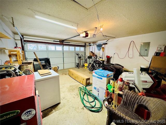 garage with electric panel, refrigerator, and a garage door opener