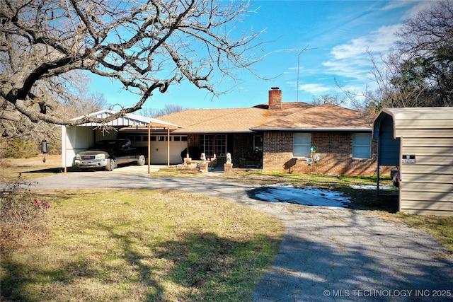 ranch-style home with a front yard and a carport