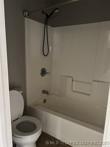 bathroom with bathtub / shower combination and toilet