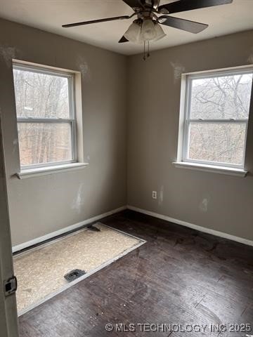 unfurnished room featuring ceiling fan and dark hardwood / wood-style flooring