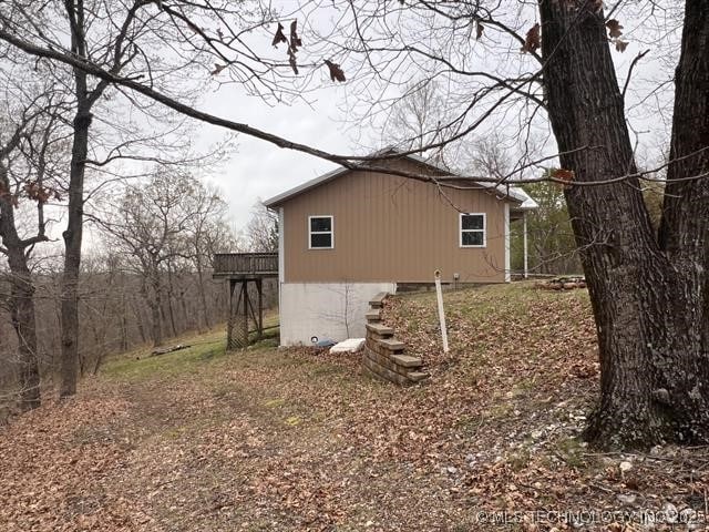 view of side of home with a wooden deck