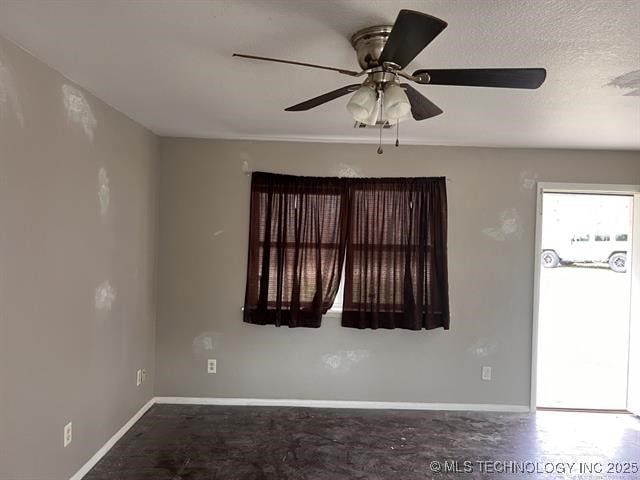 spare room with ceiling fan