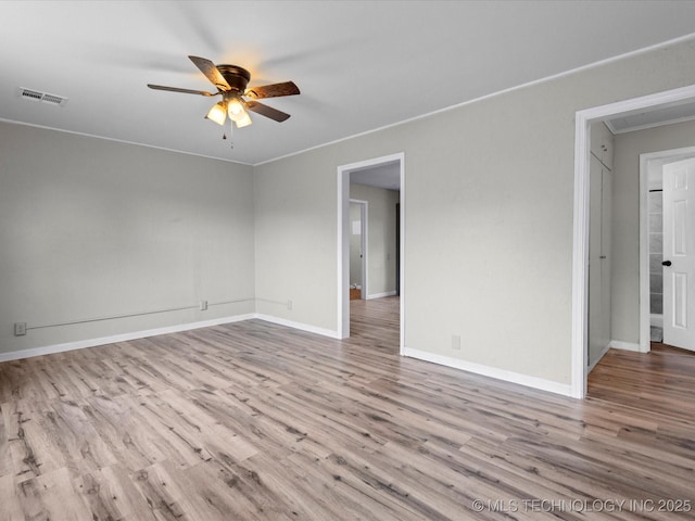 spare room with light wood-type flooring and ceiling fan