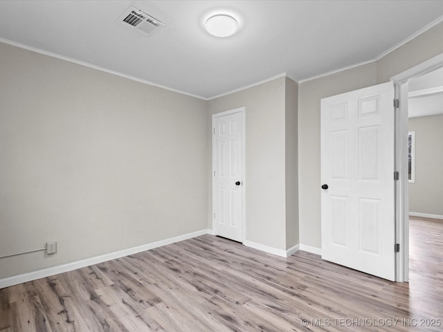 unfurnished bedroom with light hardwood / wood-style flooring and crown molding