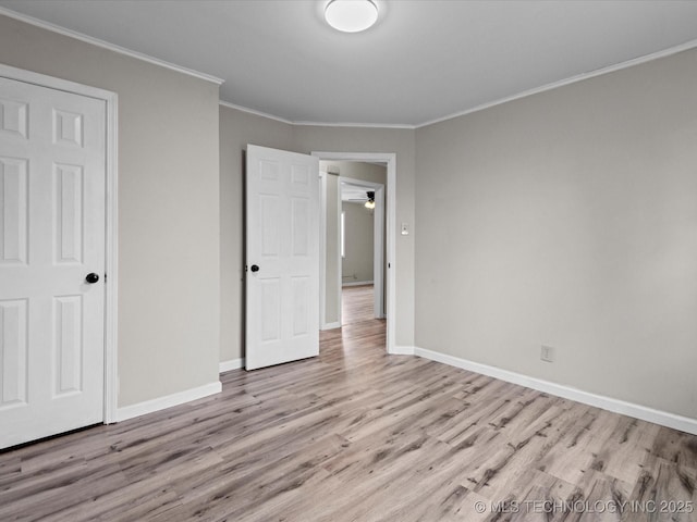 unfurnished bedroom featuring light hardwood / wood-style floors, a closet, and crown molding