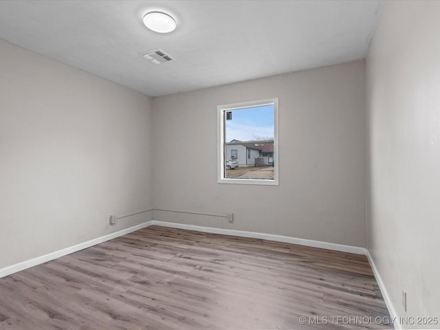 unfurnished room with light wood-type flooring