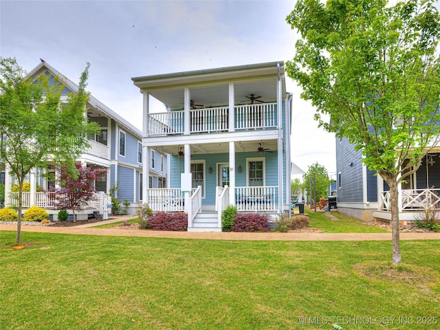 view of front facade with a balcony, a front lawn, and a porch