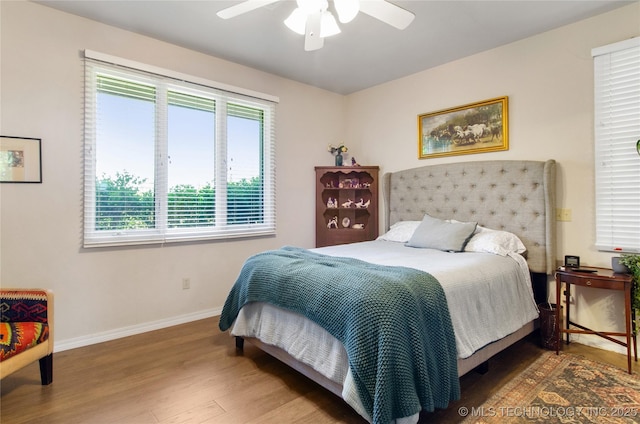 bedroom with ceiling fan and hardwood / wood-style flooring