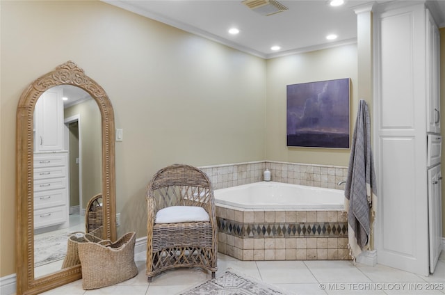 bathroom featuring tile patterned flooring, ornamental molding, and tiled tub