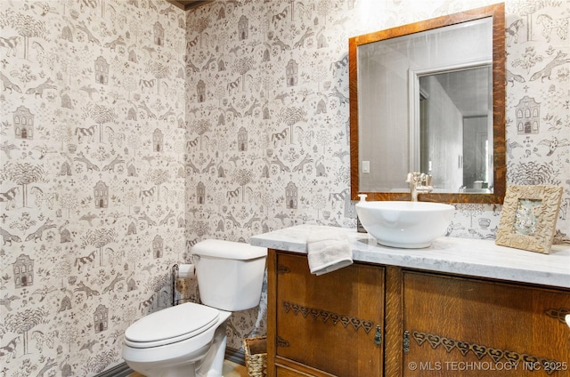 bathroom featuring vanity and toilet