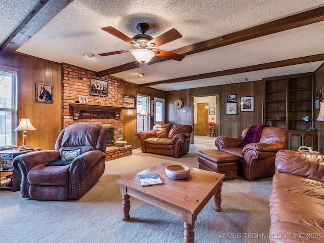 carpeted living room featuring beamed ceiling, a textured ceiling, plenty of natural light, and wood walls