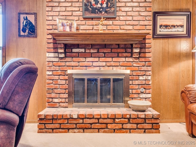 room details with carpet floors, a brick fireplace, and wooden walls