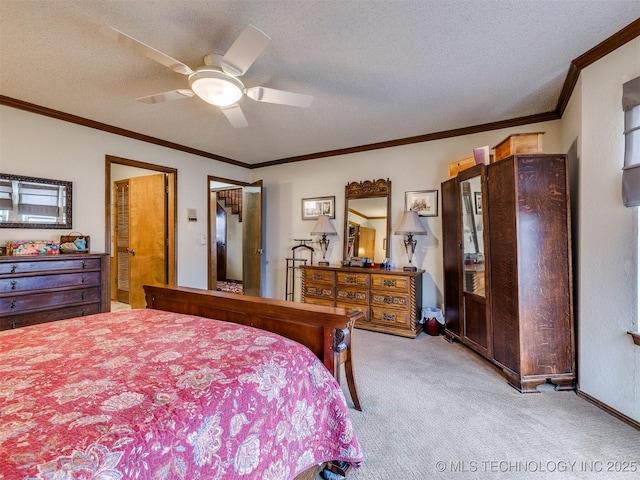 carpeted bedroom featuring a textured ceiling, ceiling fan, and ornamental molding