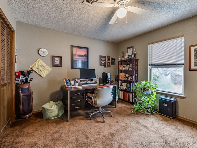 office space featuring a textured ceiling, light colored carpet, and ceiling fan