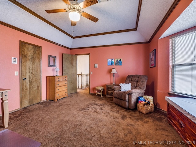 living area with dark carpet, a textured ceiling, vaulted ceiling, ceiling fan, and crown molding