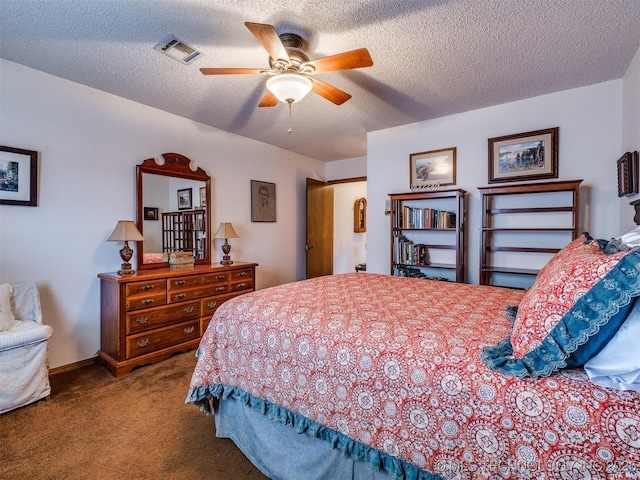 carpeted bedroom featuring ceiling fan and a textured ceiling