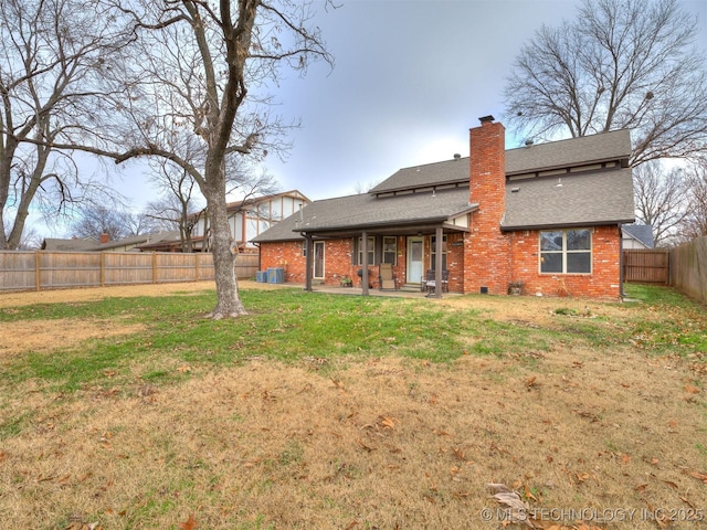 back of property featuring central AC unit, a yard, and a patio