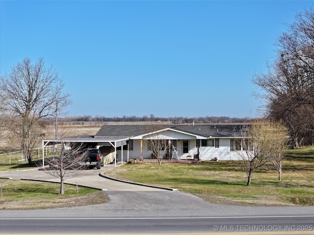 single story home with driveway, an attached carport, and a front yard