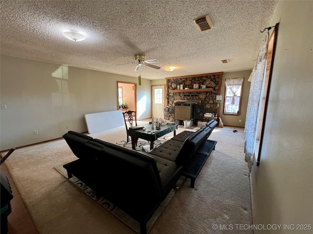 carpeted living room with ceiling fan and a textured ceiling