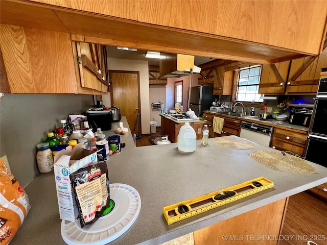 kitchen featuring sink, stainless steel fridge, black double oven, white dishwasher, and extractor fan