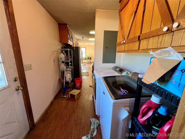 laundry area featuring cabinets, electric panel, washer and dryer, dark hardwood / wood-style floors, and a textured ceiling