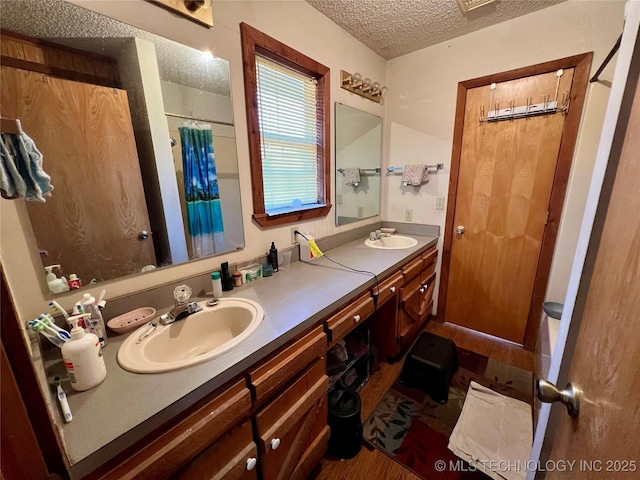 bathroom featuring vanity, a textured ceiling, and walk in shower