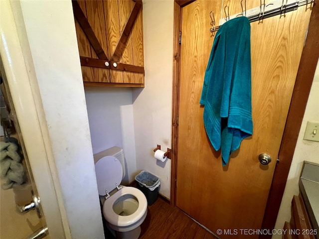 bathroom with hardwood / wood-style floors and toilet