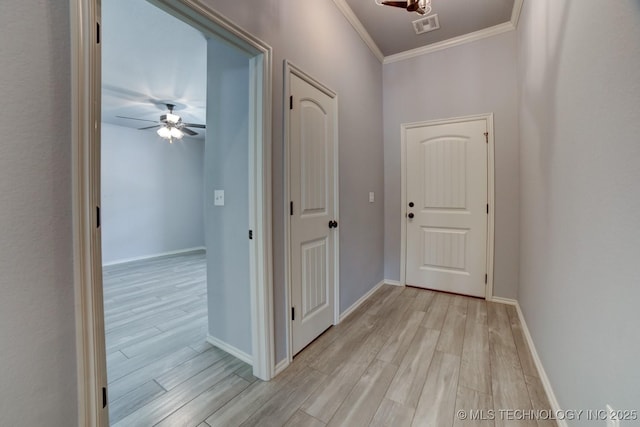 hall featuring light wood-type flooring and ornamental molding