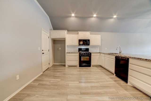 kitchen with black appliances, crown molding, sink, light stone countertops, and light hardwood / wood-style floors